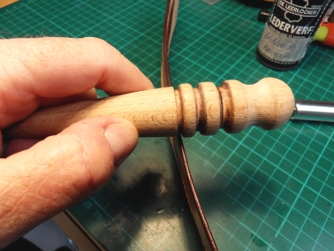 Burnishing the edges with the wooden slicker Burnishing the edges with the wooden slicker